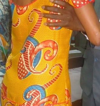 Two people embracing at a community gathering